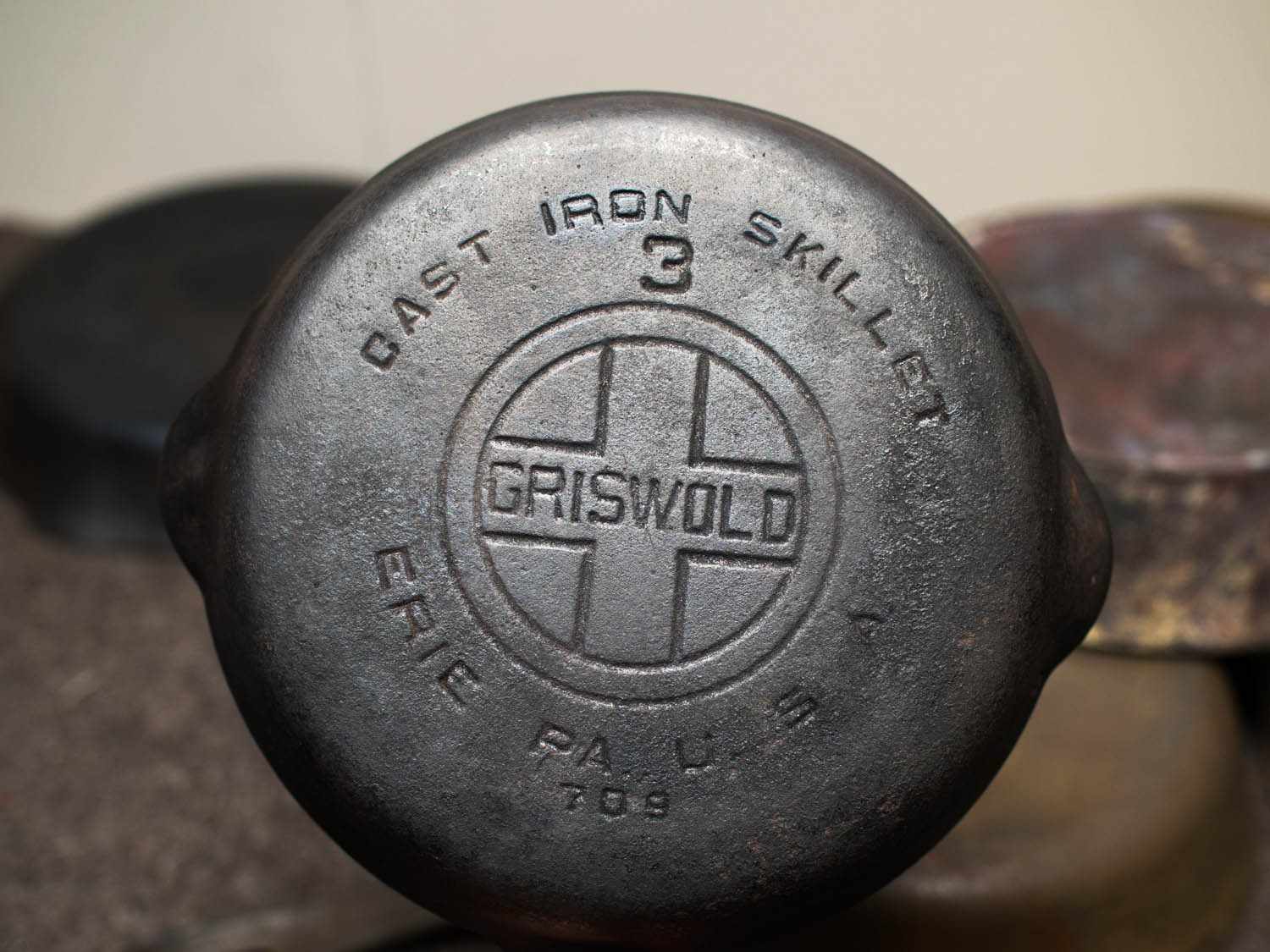 A backside view of a cast iron skillet from the brand "Griswold".