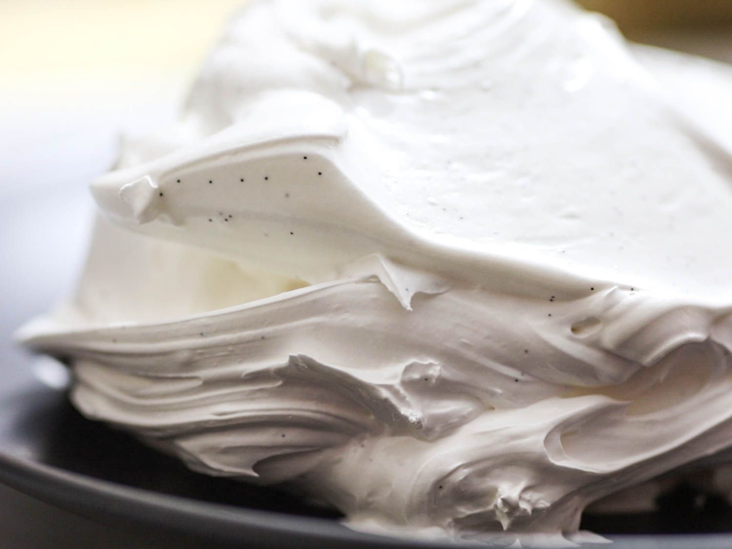 A mound of Swiss meringue flecked with vanilla beans