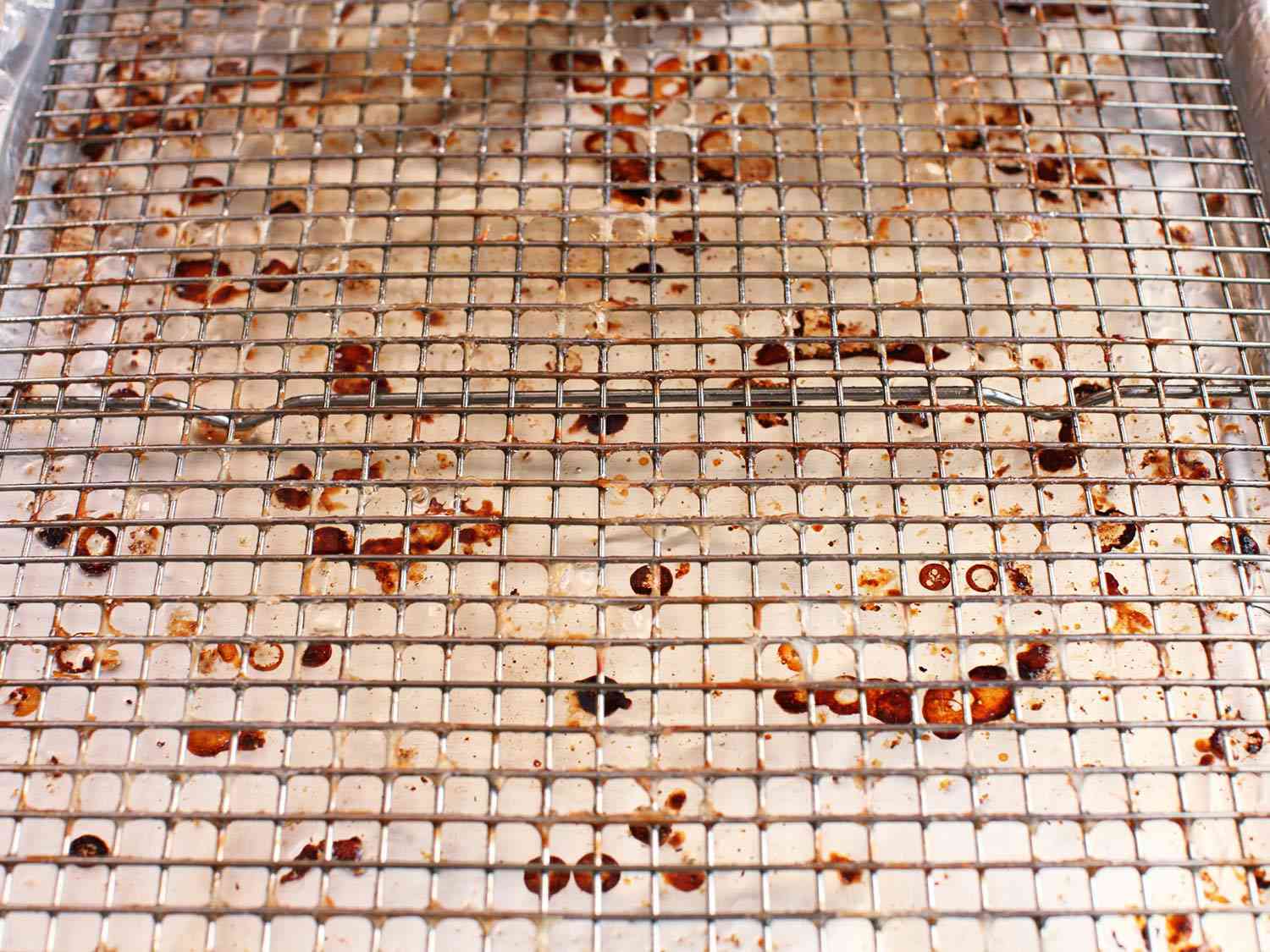 The bacon residue-encrusted wire rack after use.