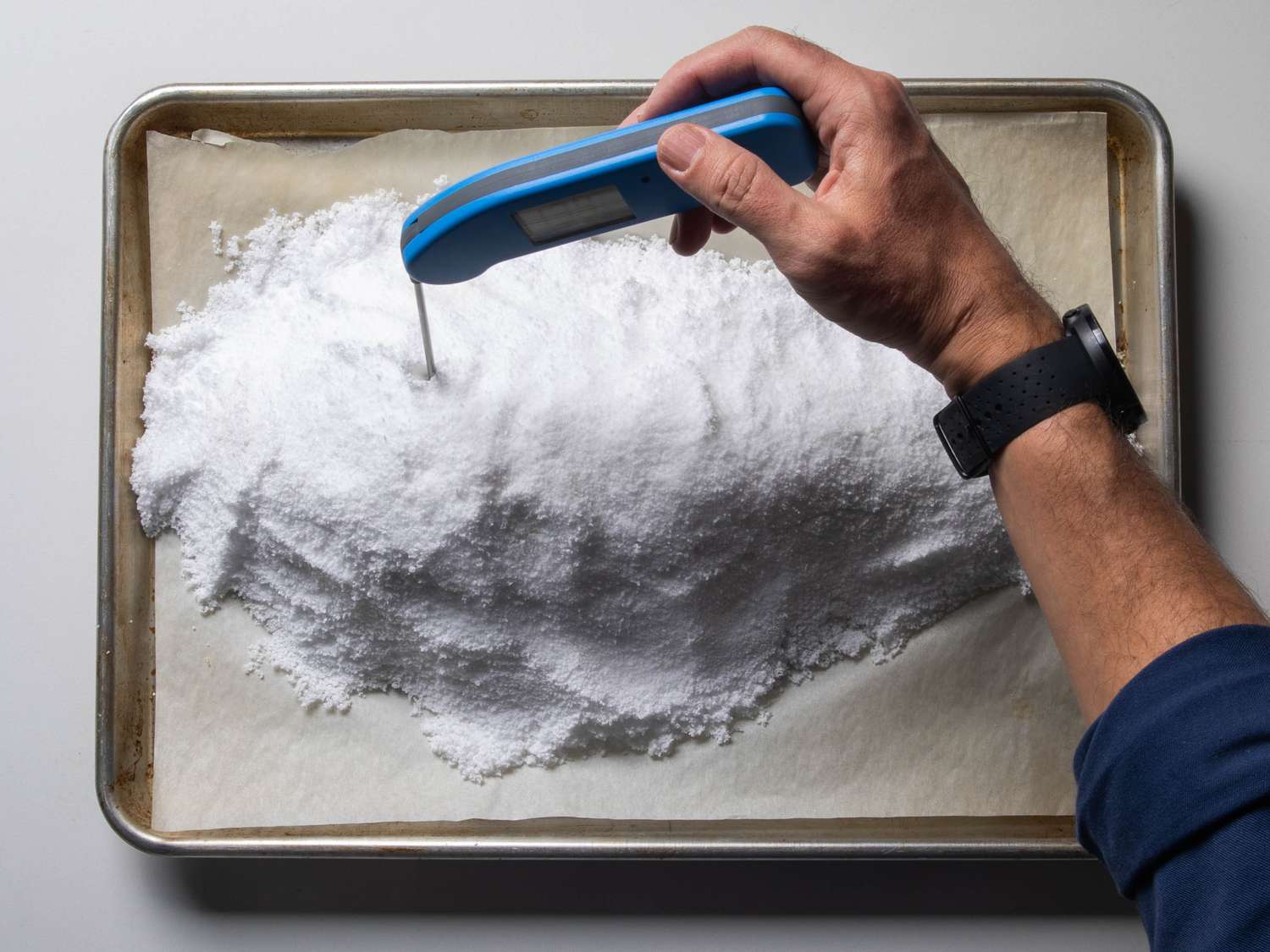 Checking the fish temperature with an instant-read thermometer.