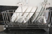 The Rubbermaid dish rack full of dishes.