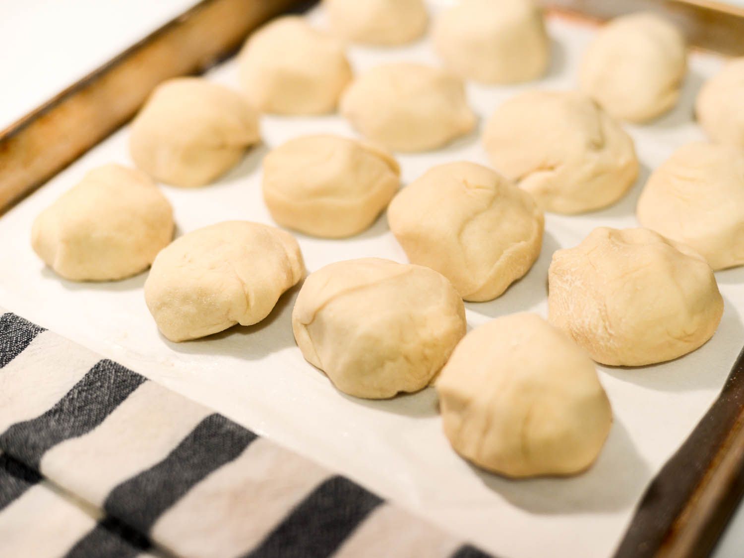 Individual formed balls of flour tortilla dough.
