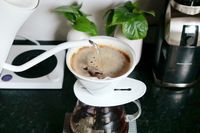 Pouring water into a pour-over coffee maker