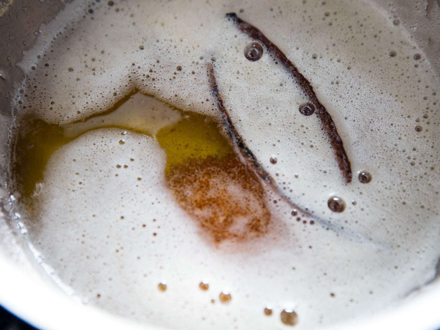 Vanilla pods infusing in pot of browning butter.