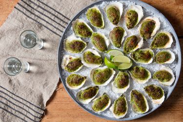 Overhead shot of a circular platter of Oysters Rockefeller Oaxaca-style on ice