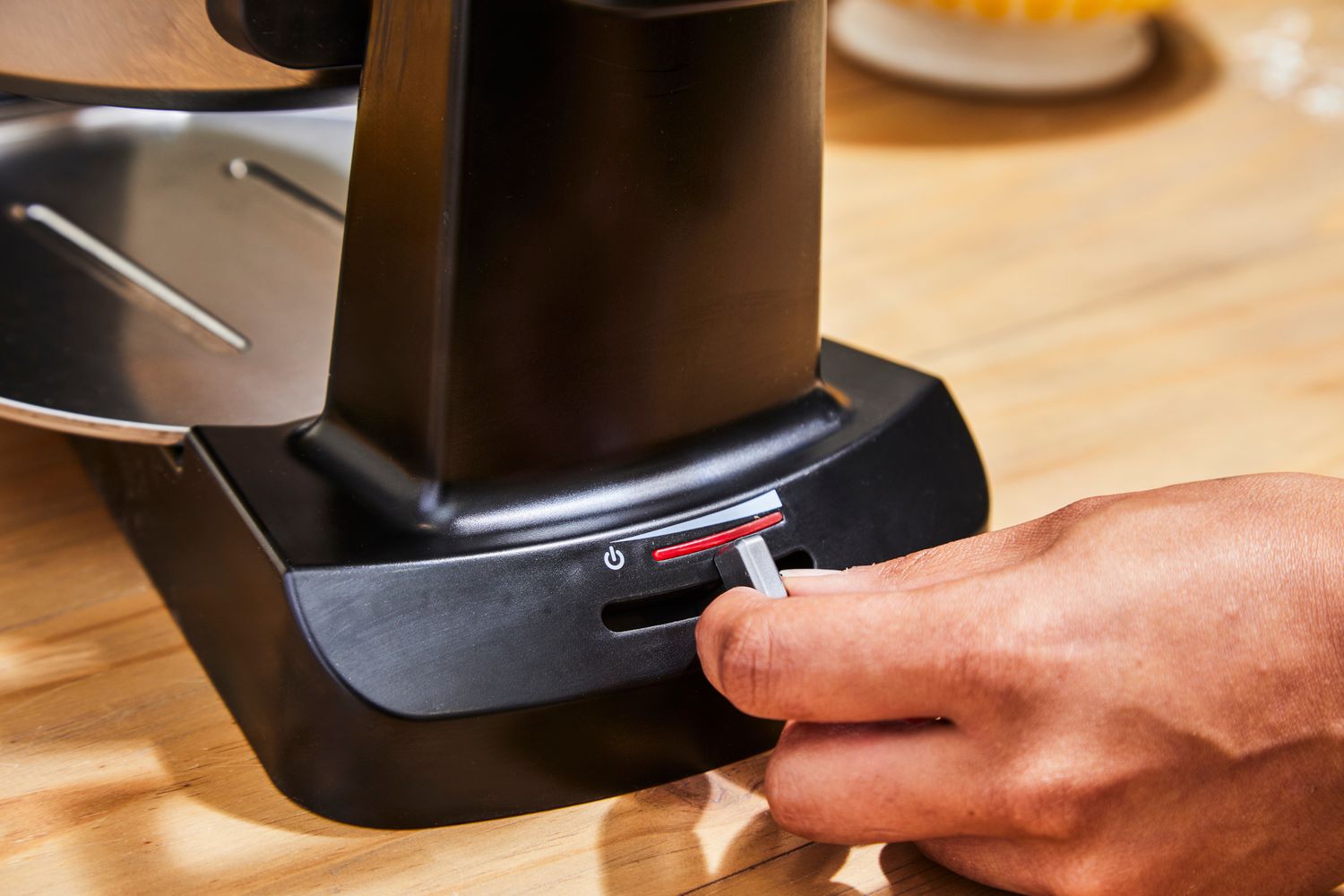 Person turning on Cuisinart WAF-F4 Double Flip Belgian Waffle Maker