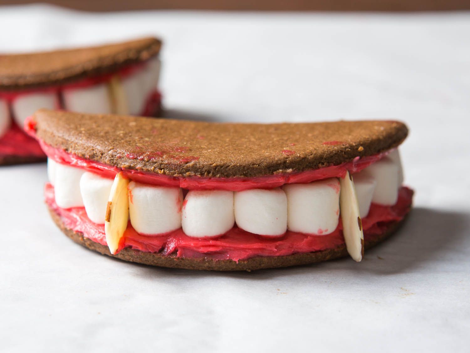 Front view of vampire teeth sandwich cookie.