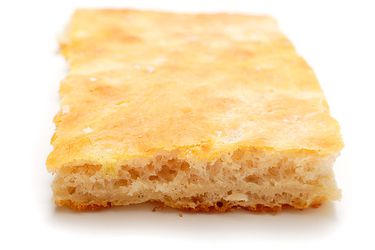 Closeup profile view of a slice of pizza bianca.