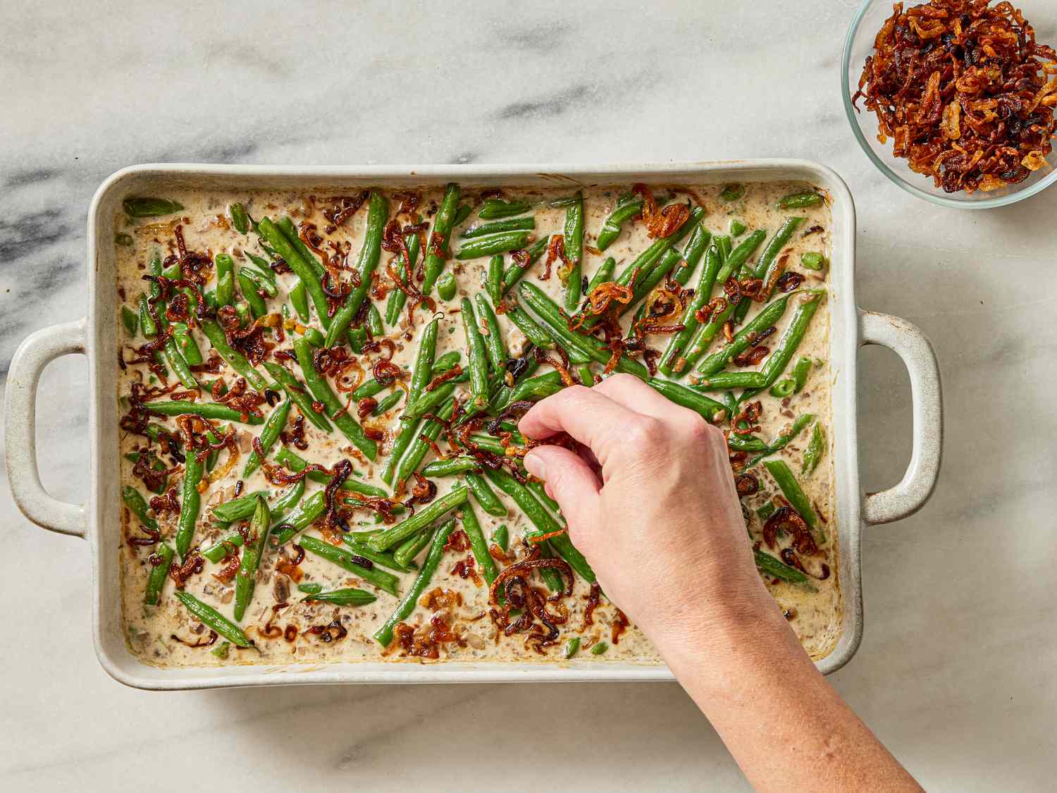 Overhead view of adding shallots