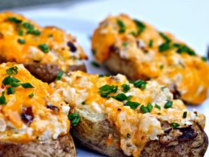 Close up of grilled, loaded twice-baked potatoes, ready to serve.
