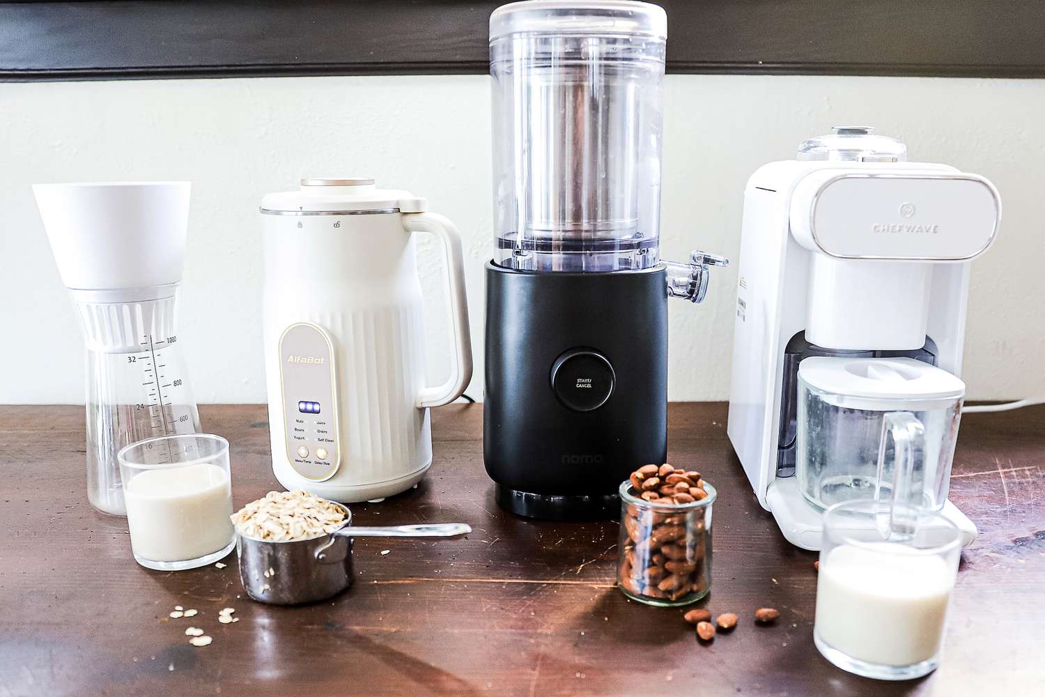 four nut milk makers on a wooden countertop