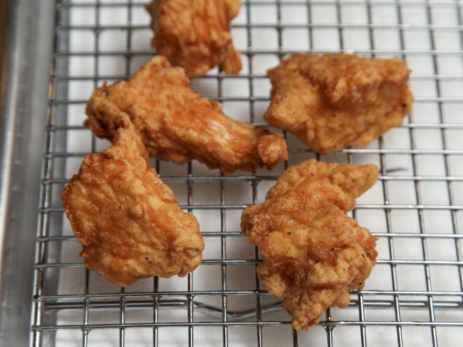 Boneless chicken thighs coated in thick eggy marinade and dry cornstarch before frying.