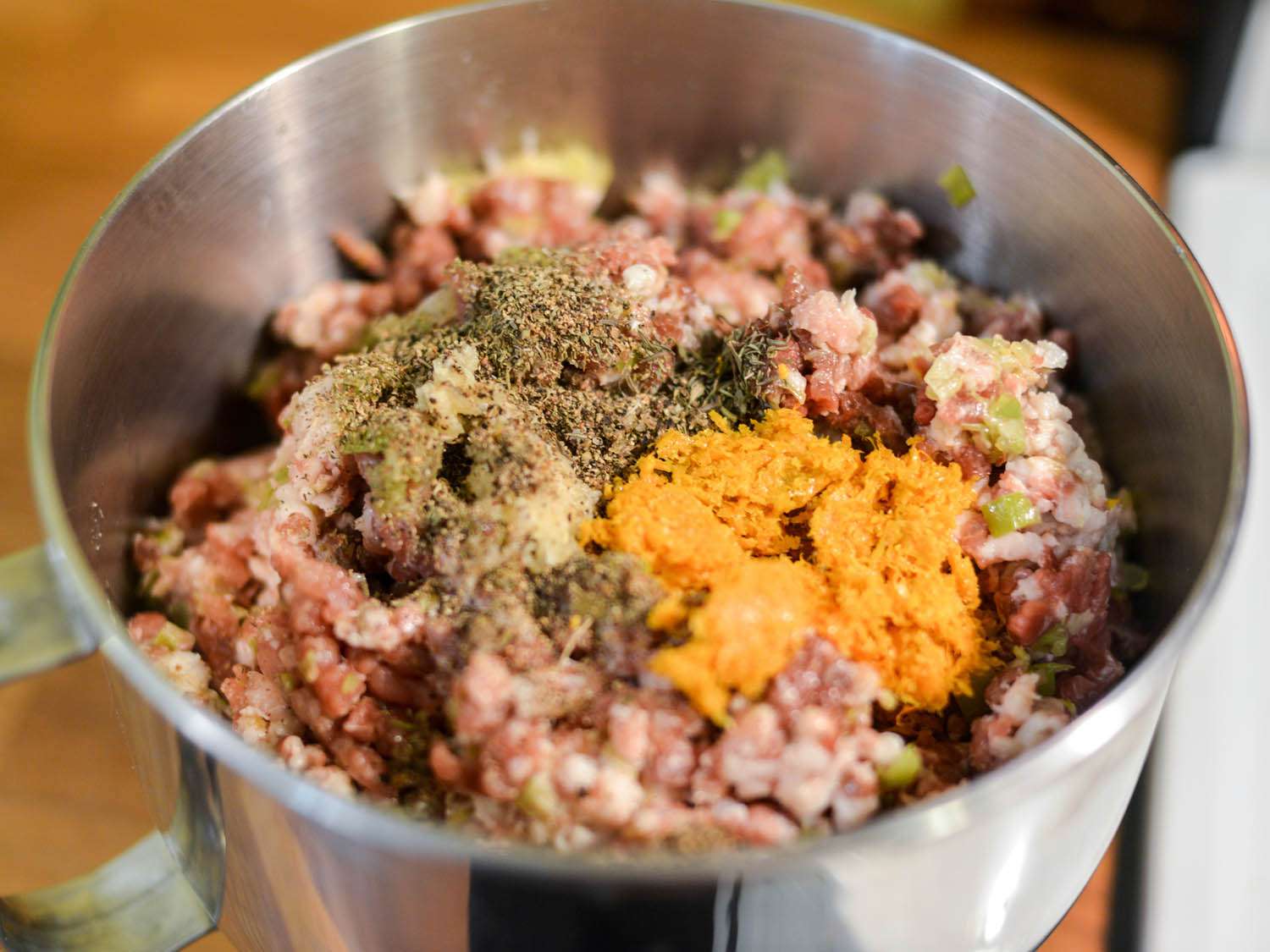 Ground meat, fatback, and cooked leeks are mixed with herbs, spices, and orange zest.