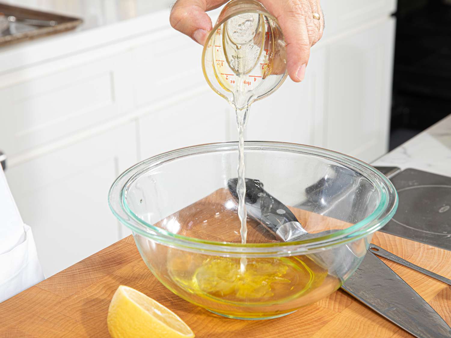 Side view of adding oil to dressing