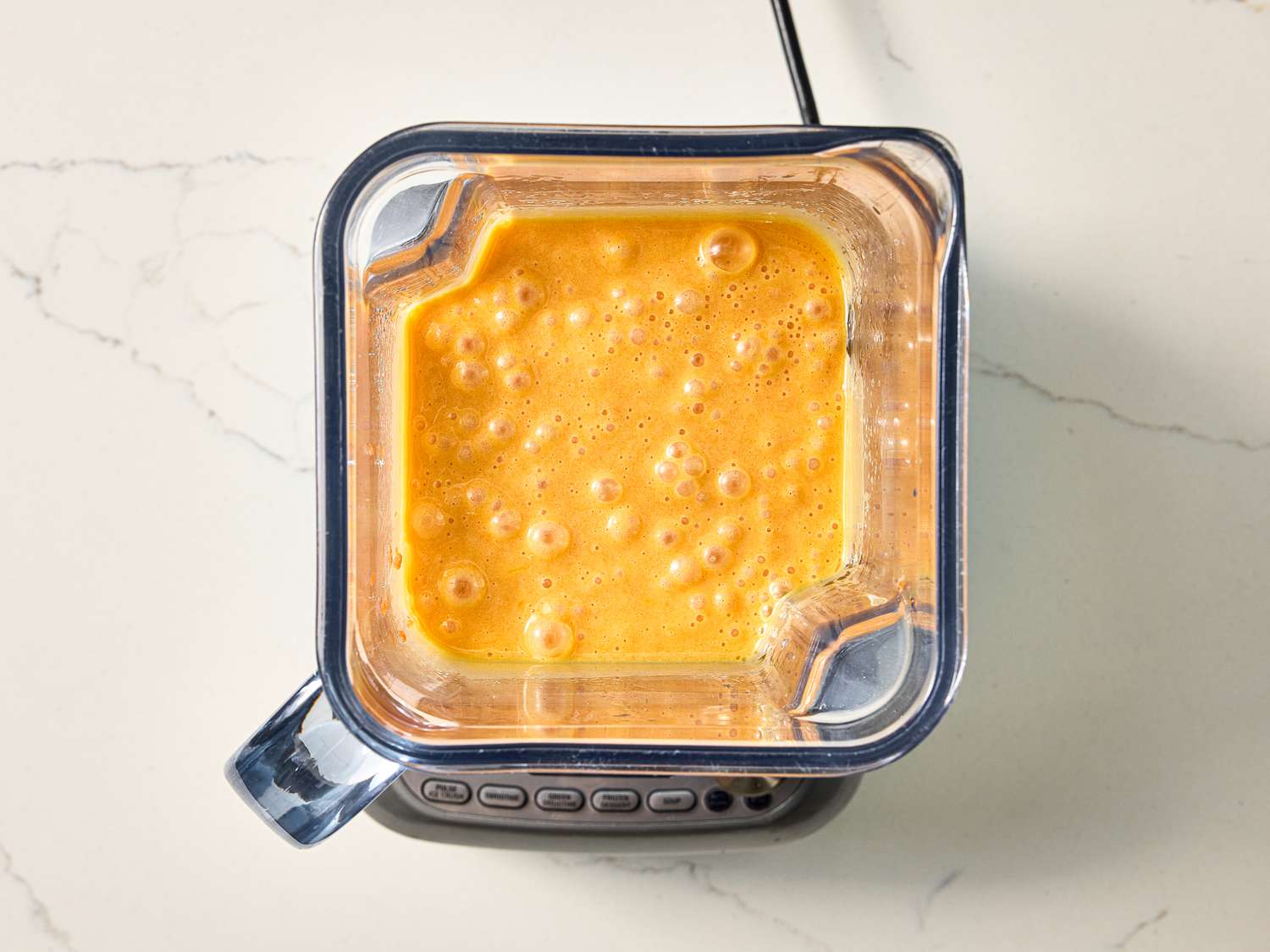Blender containing a mixture being processed, viewed from above