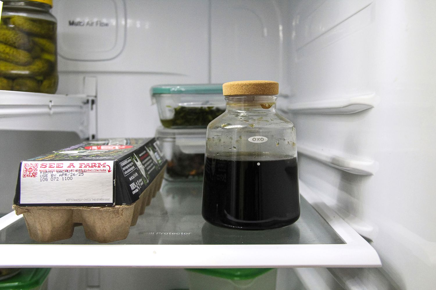 The OXO cold brew maker on a fridge shelf.