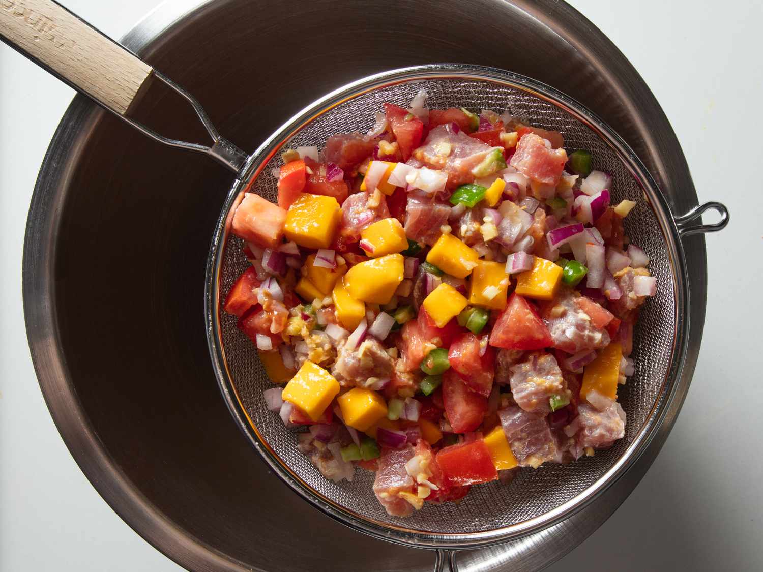 straining kinilaw of excess liquid