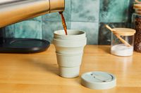 Coffee being poured into a Stojo travel cup.