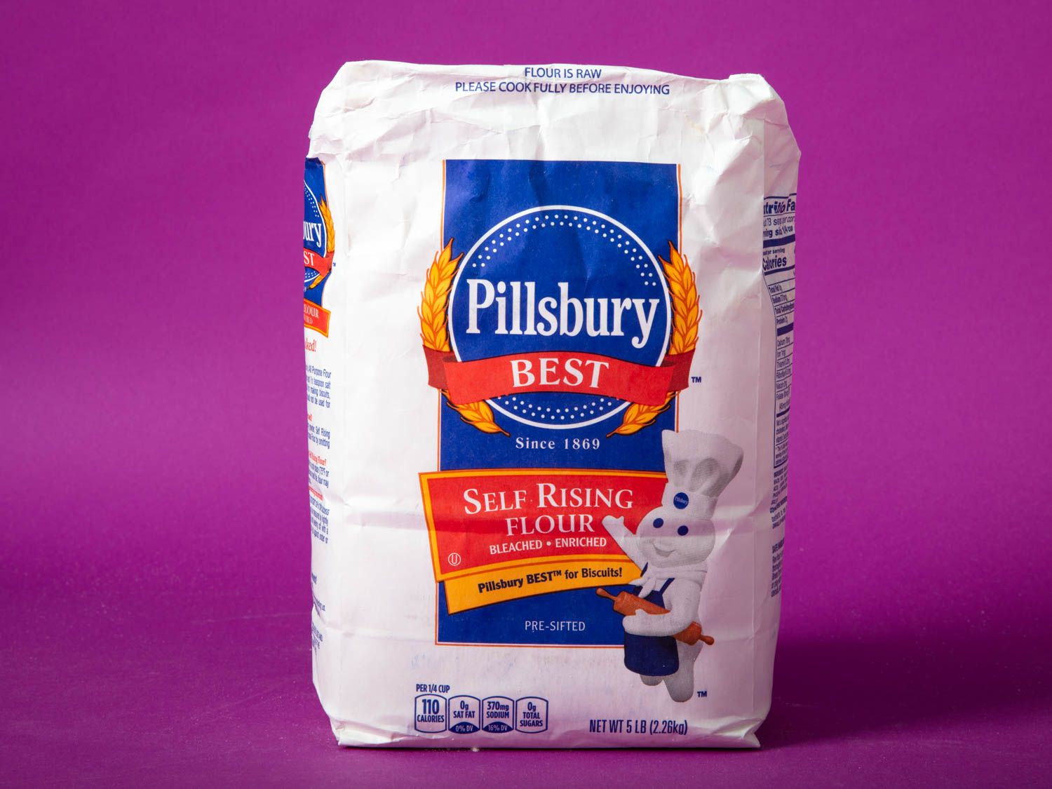 A bag of Pillsbury self-rising flour against a purple background.