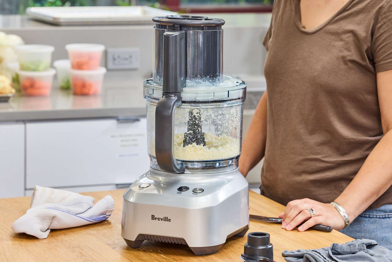 A person uses the Breville BFP660SIL Sous Chef 12-Cup Food Processor