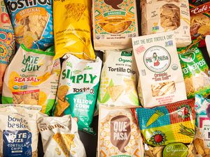 A variety of tortilla chip brands in colorful packaging arranged together