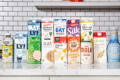 A selection of various oat milk brands displayed on a counter