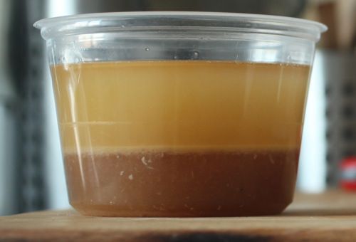 Drained fat and cooking liquid from braised carnitas.