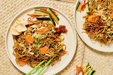 Stir-fried noodles with vegetables on a plate.