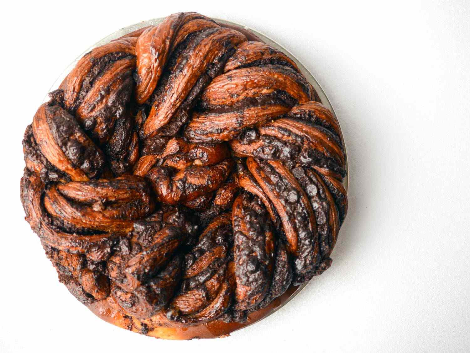 Overhead photo of circular, intricately braided chocolate babka.