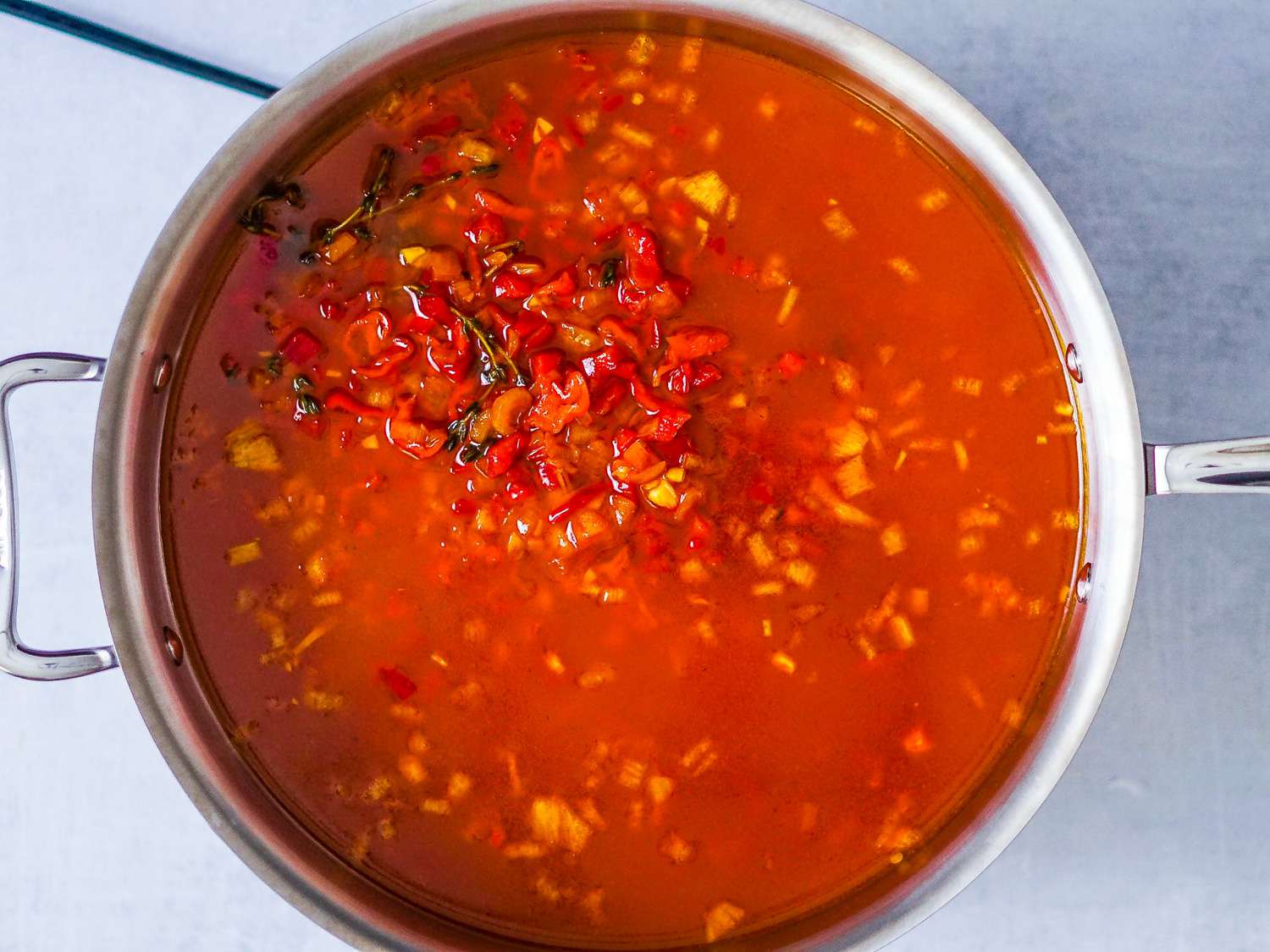 The diluted marinade is transferred to a sauté pan.