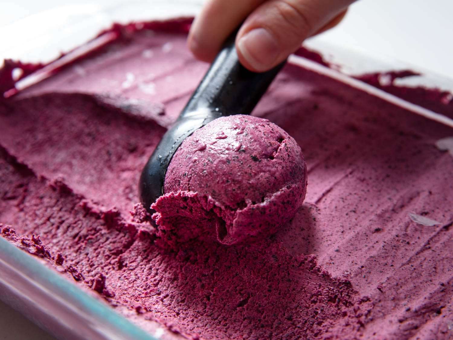 scooping blueberry ice cream