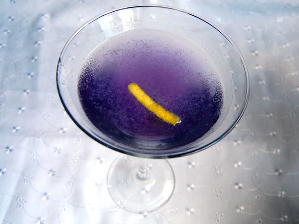 A blue moon cocktail served in a martini glass.
