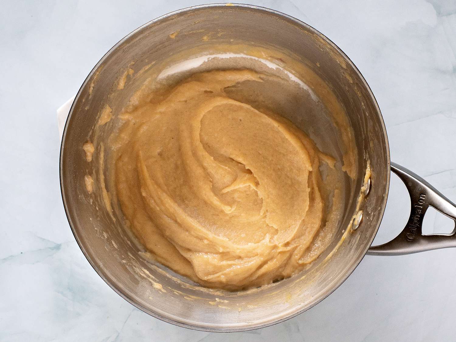 The completed churro batter resting in a saucepan.