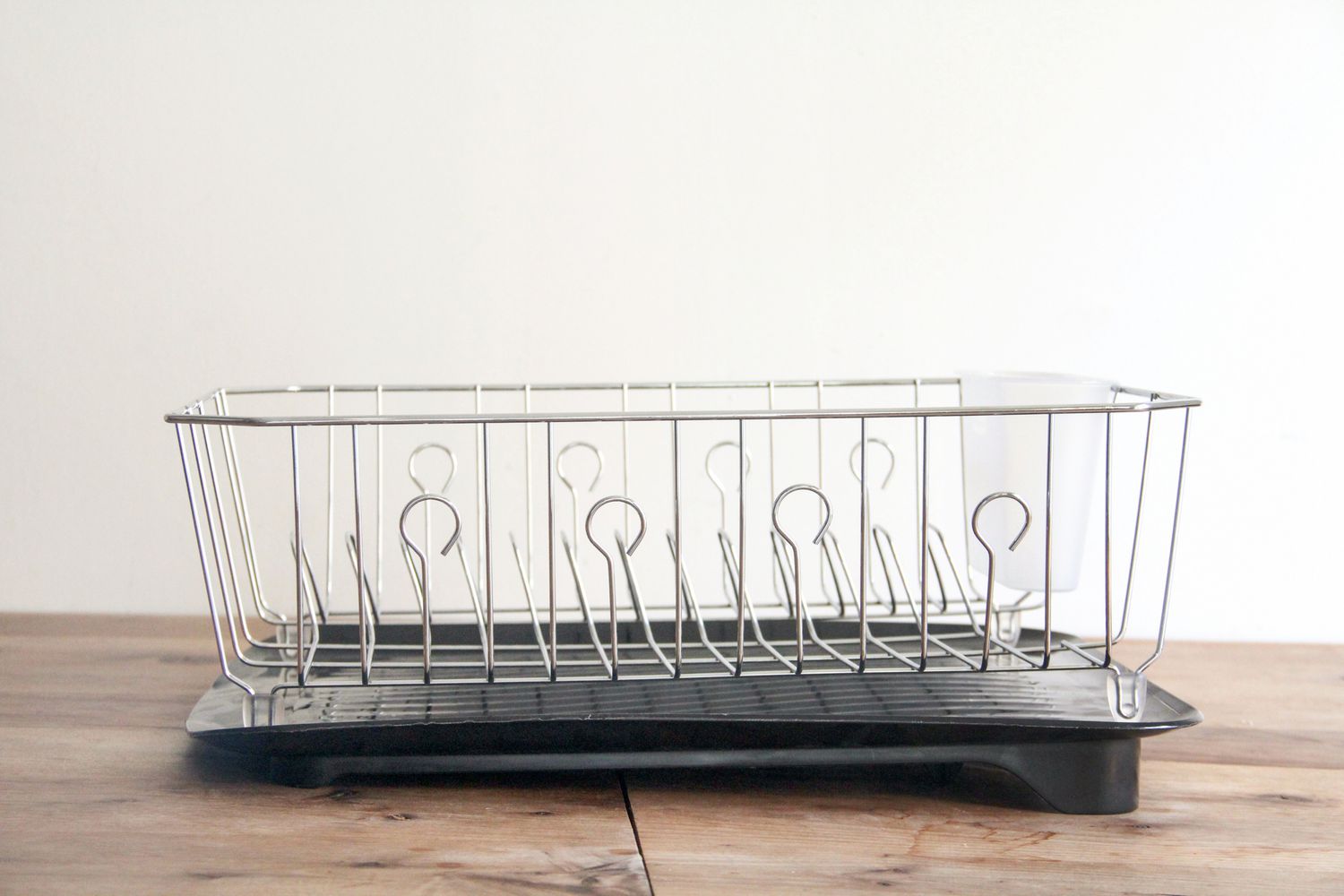 The Rubbermiad dish rack on a wooden countertop.