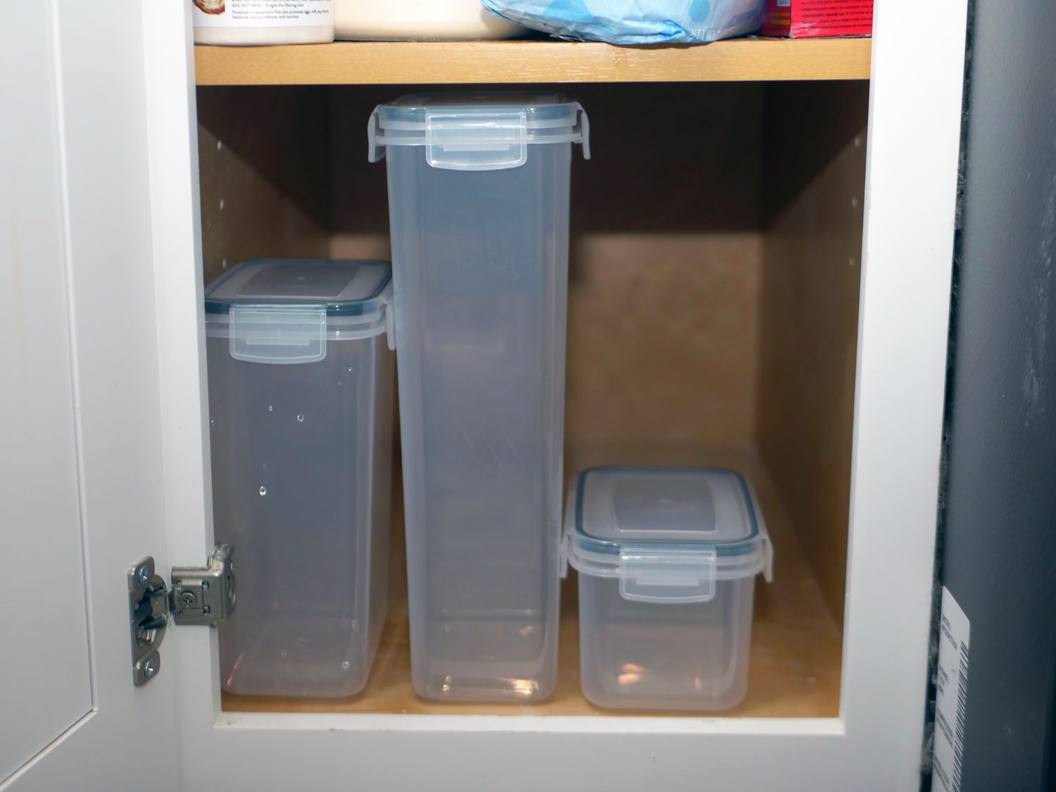 three containers on a pantry shelf