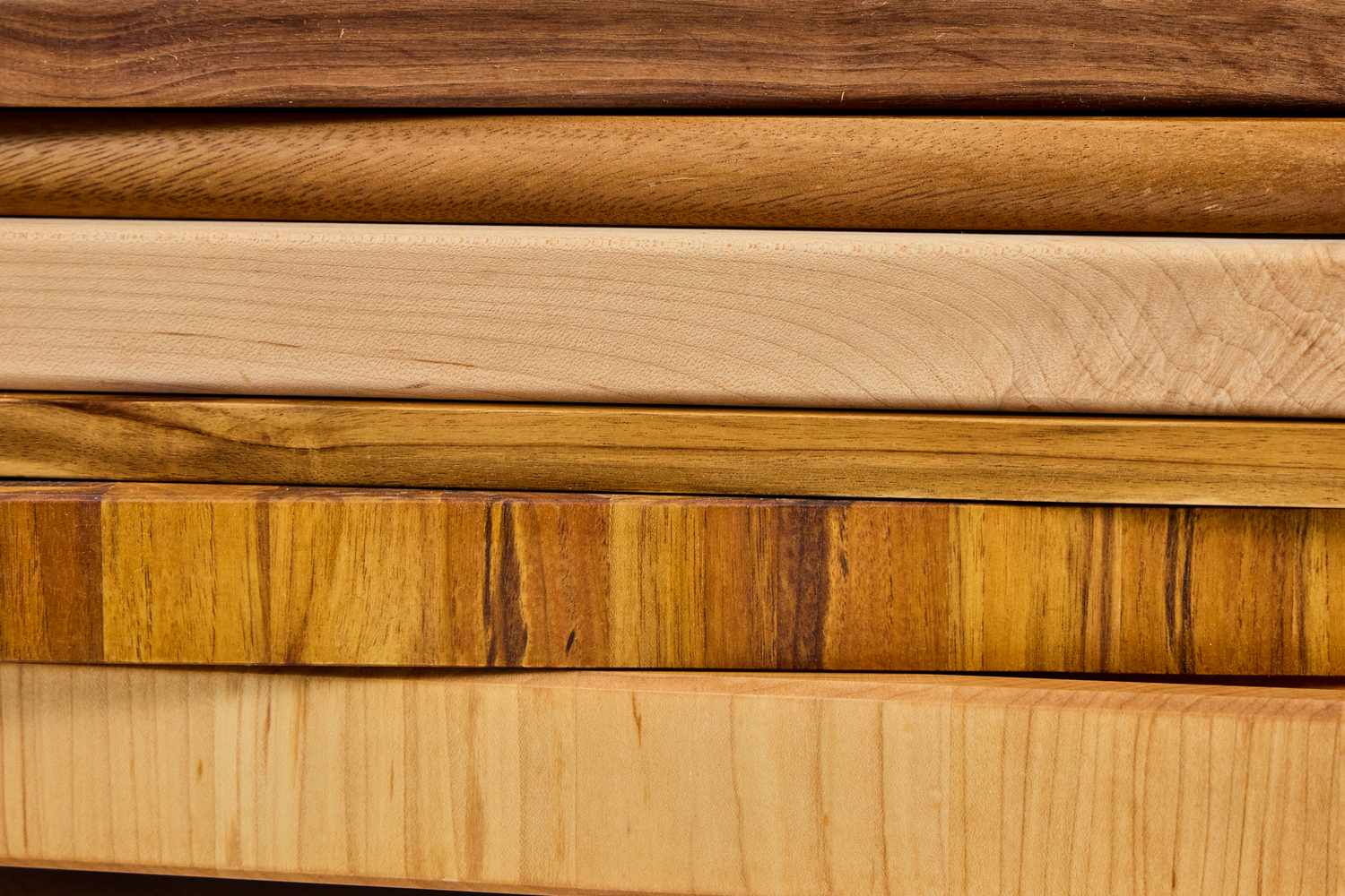 A closeup photo of a stack of wooden carving boards