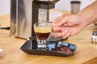 A glass of espresso made using the Lelit William Espresso Grinder