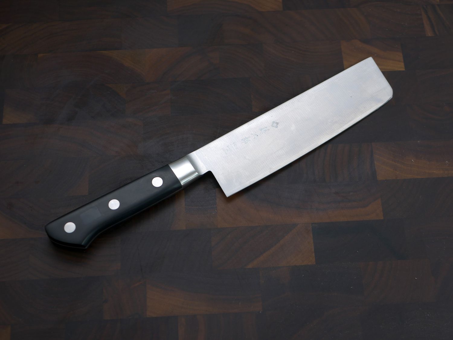 Fujiro Tojiro Nakiri knife on a wooden cutting board