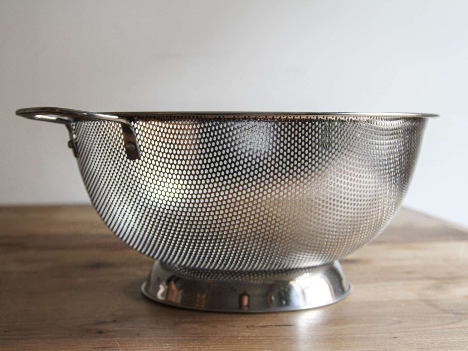 a closeup look at the RSVP colander sitting on a wooden surface