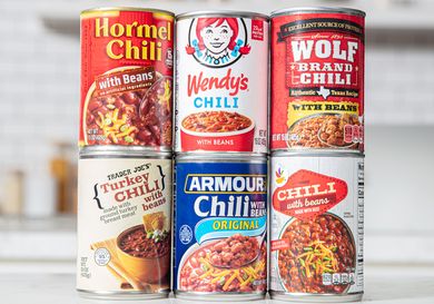 A selection of canned chili brands including Hormel Wendys Wolf Brand Trader Joes Armour and Chili with Beans