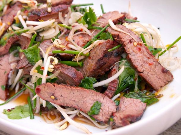 Close up view of Thai-style marinated flank steak and herb salad. 
