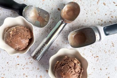 a few ice cream scoops with scoops of ice cream in bowls