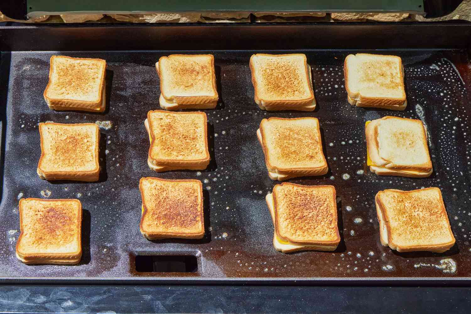 Grilled cheese are cooked on the Traeger Flatrock Flat Top Grill