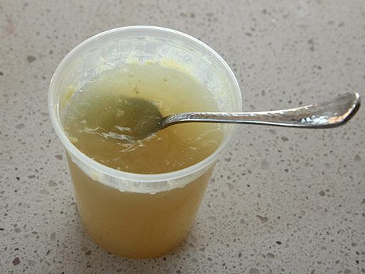 A congealed pork broth made from pork neck bones in a deli container. 