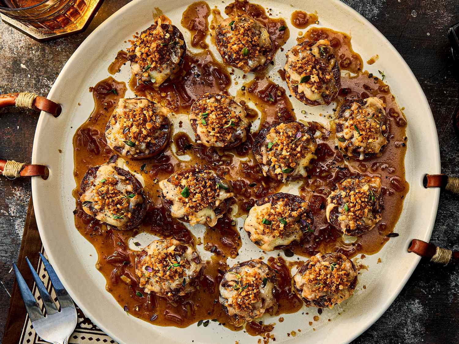 Plate of French onion soup potato bites garnished and photographed from above