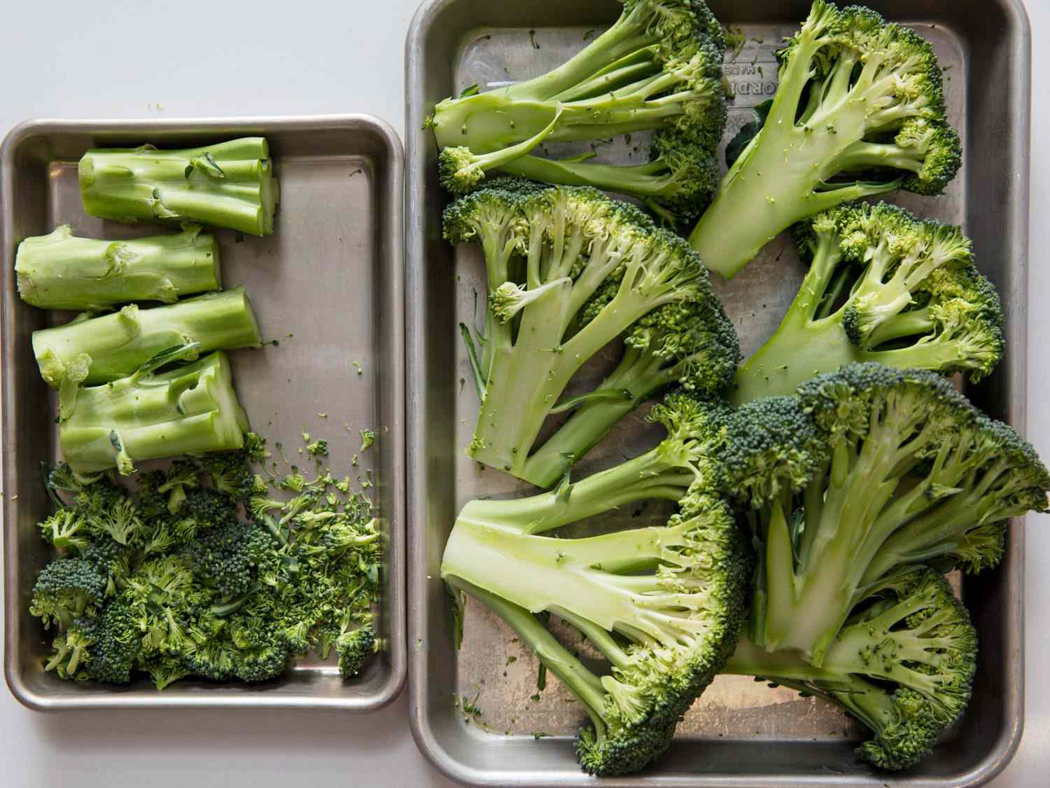 Broccoli cut into steaks, stems, and floret scraps.