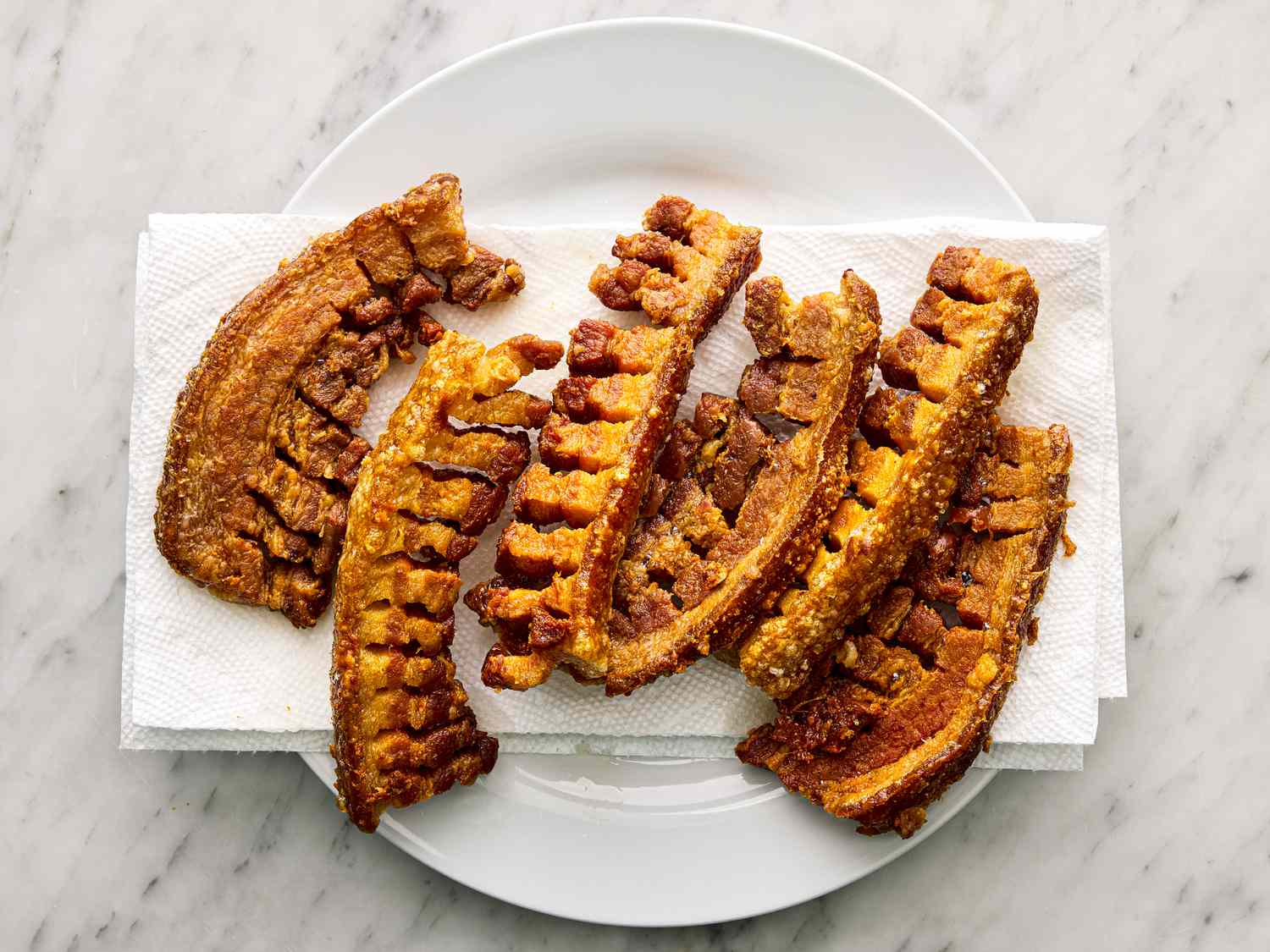 Crispy chicharrones on a paper towel drying out. 