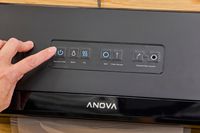 A person presses a button on the Anova Precision Vacuum Sealer Pro