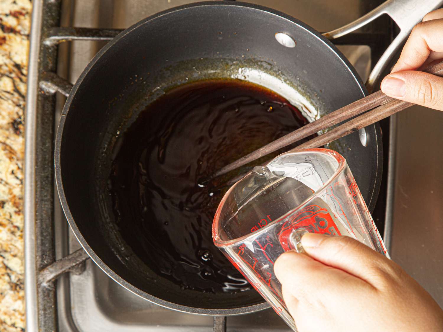 Coconut water being added to caramel