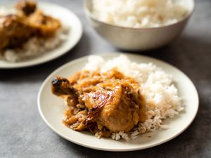 Chicken yassa on a bed of white rice.